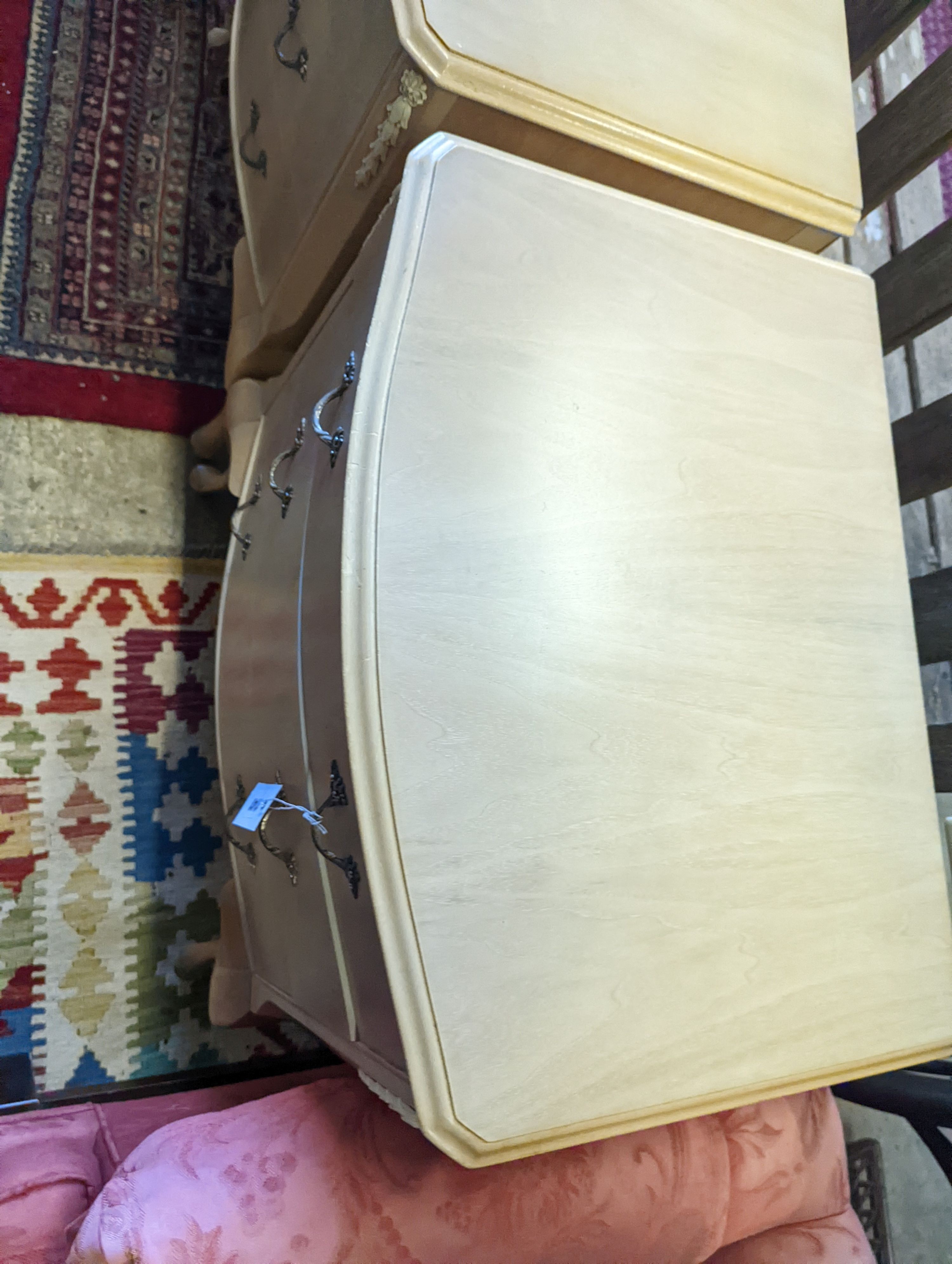 A pair of pale walnut three drawer bedside chests, width 60cm, depth 45cm, height 74cm